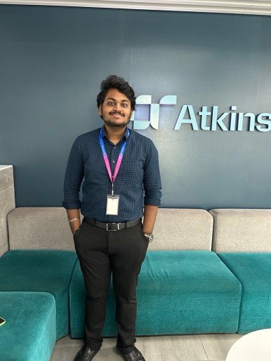 Sujith in front of atkinsrealis logo